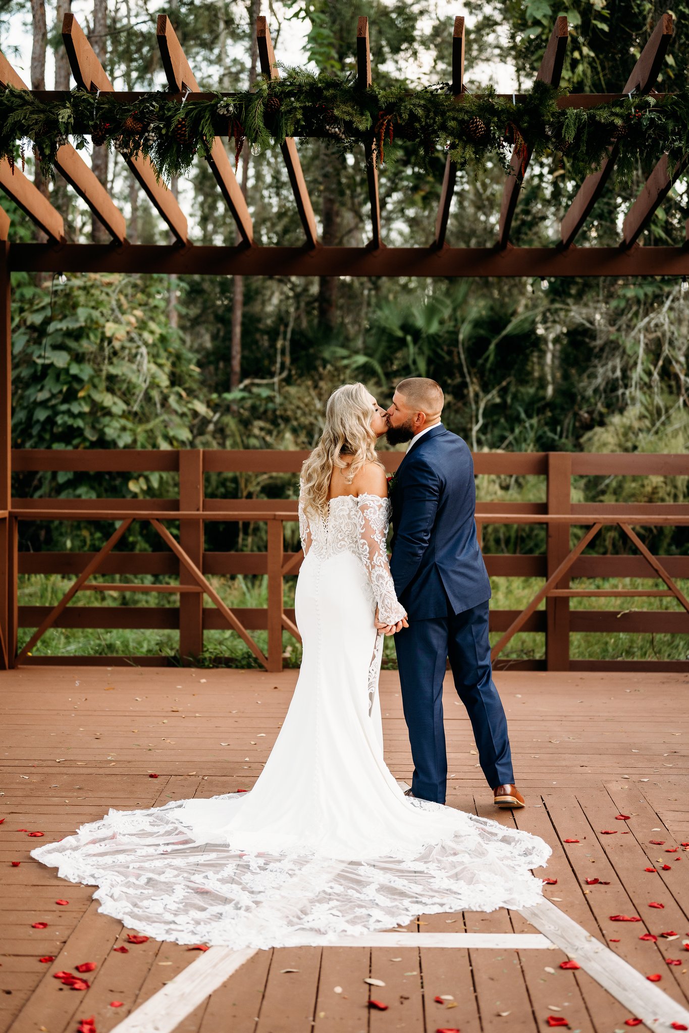 First kiss beneath the garlanded pergola
