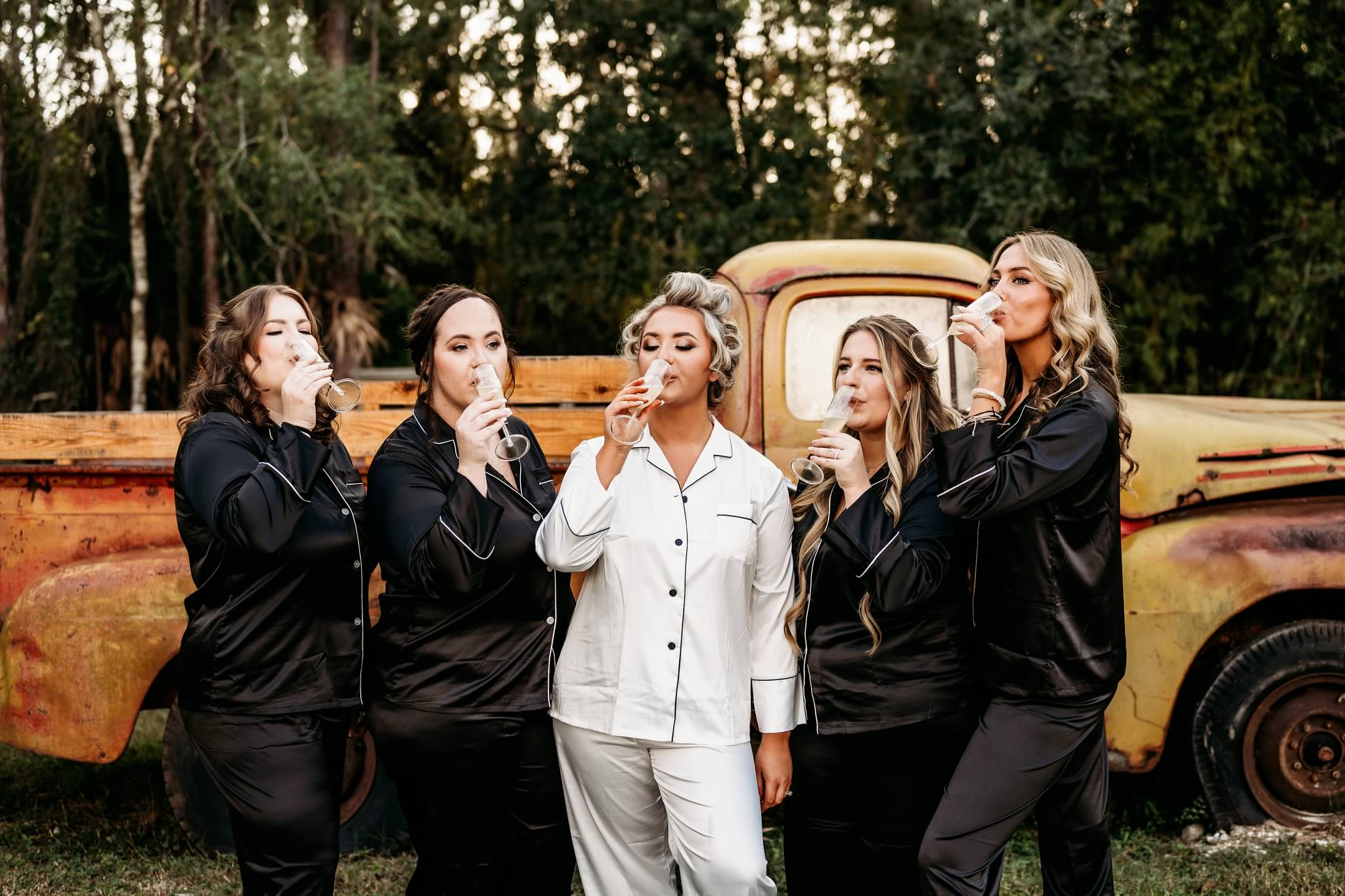 Bridal party toast at the vintage yellow truck