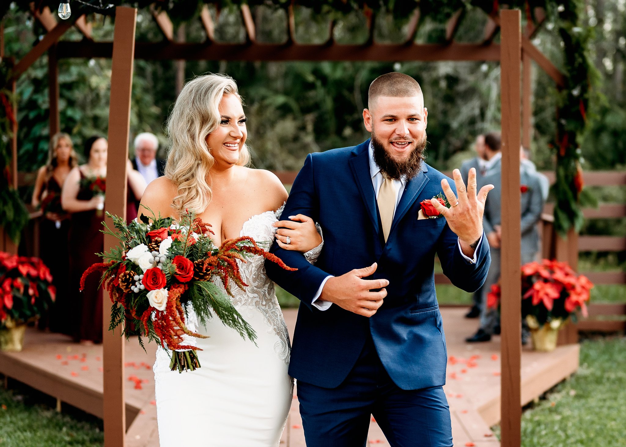 Just-married couple laughing down the aisle