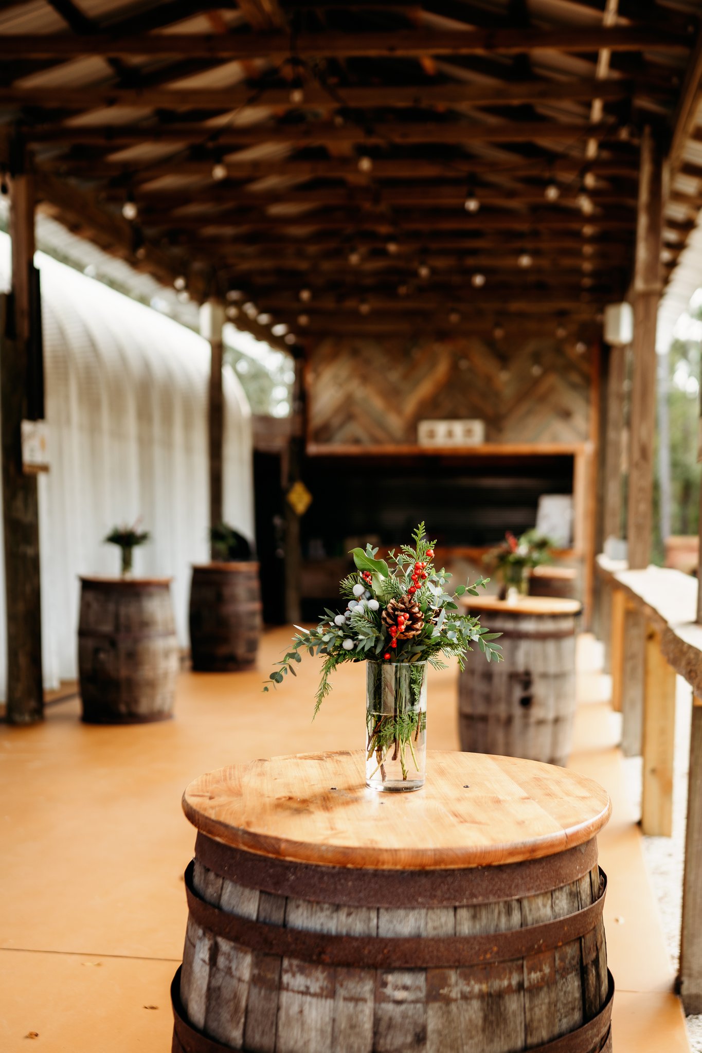 Covered patio bar with whiskey-barrel cocktail tables