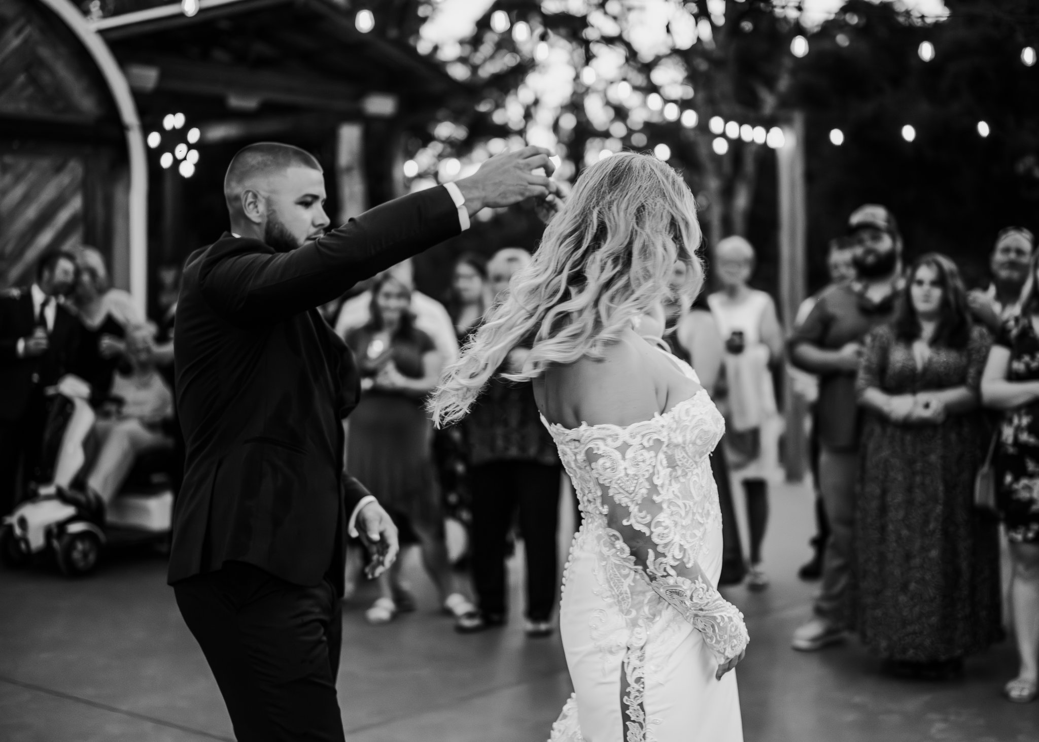 First-dance twirl on the outdoor dance floor at dusk